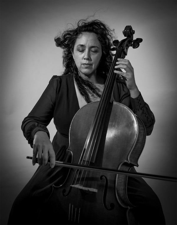 black and white image of woman playing cello