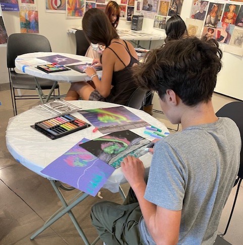students at art table