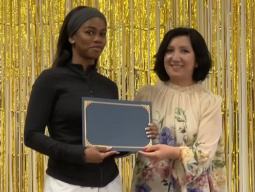 student on stage with counselor