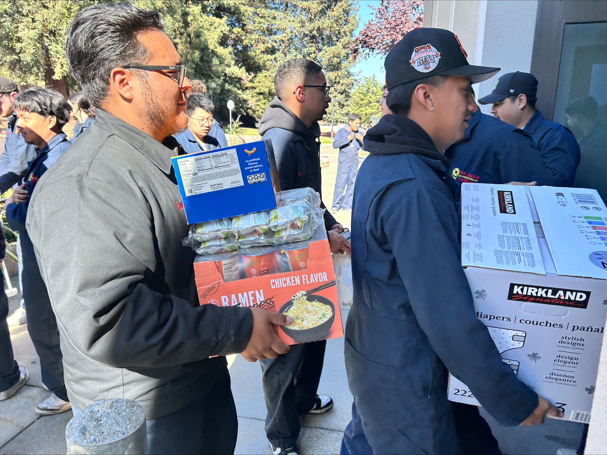 students unloading cases of food